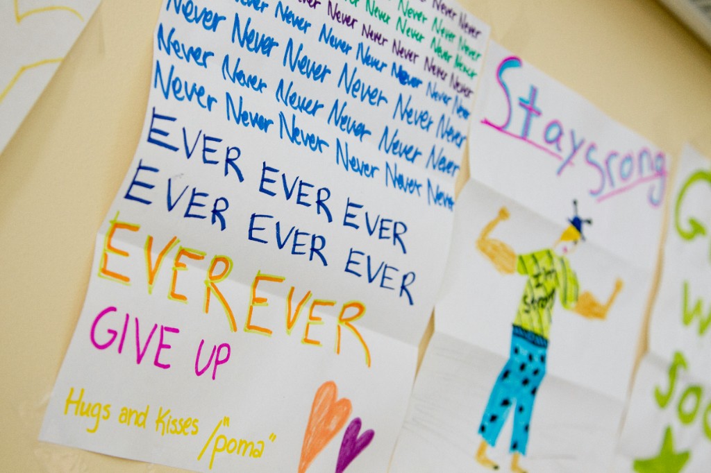 Hand-drawn encouraging notes on a wall with messages to stay strong